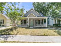 Charming single-Gathering home with a welcoming front porch, green front door, and a well-maintained lawn at 1429 Swamp Fox Ln, Charleston, SC 29412