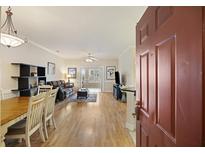 Inviting living room with hardwood floors seamlessly blending dining and living areas with natural light at 1984 Folly Rd # A307, Charleston, SC 29412