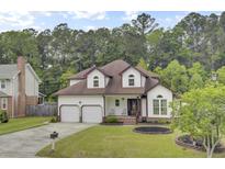 Charming two-story home featuring a well-manicured lawn and a two-car garage at 204 Knightsbridge, Charleston, SC 29418