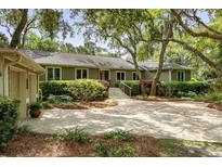 Charming single-story home featuring manicured landscaping and a spacious driveway at 2355 Andell Way, Seabrook Island, SC 29455