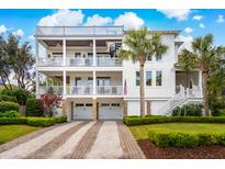 Stunning three-story beach house with multiple balconies, a spiral staircase, and well-manicured landscaping at 3 37Th Ave, Isle of Palms, SC 29451