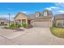Charming single-Gathering home with a stone and siding exterior, featuring a two-car garage and well-manicured landscaping at 301 Blakely Village Ln, Summerville, SC 29486