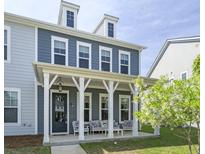 Charming two-story home with a welcoming front porch and manicured lawn at 3130 Sturbridge Rd, Mount Pleasant, SC 29466