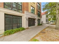 Elegant condominium building entrance featuring a gated entry and a classic brick and stucco facade at 33 Calhoun St # 123, Charleston, SC 29401