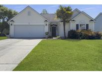 Charming single-story home with a manicured lawn, two-car garage, and inviting curb appeal at 462 Maple Oak Ln, Charleston, SC 29414