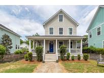 Charming two-story home featuring a welcoming front porch with classic white columns and a neatly landscaped yard at 5153 Celtic Dr, North Charleston, SC 29405