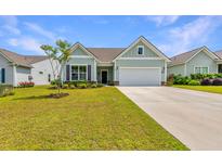 Charming single-Gathering home featuring a well-manicured lawn and a two-car garage at 6176 Wilkes Pond Dr, Hollywood, SC 29449