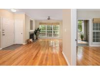 Bright living room boasts hardwood floors, fireplace, large window, and neutral paint at 700 Daniel Ellis Dr # 4104, Charleston, SC 29412