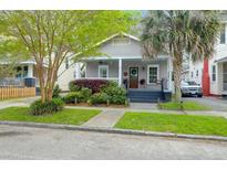 Charming single-story home with a cozy front porch and well-manicured landscaping at 71 Cypress St, Charleston, SC 29403