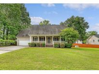 Charming single-story home featuring a welcoming front porch, lush lawn, and attached garage at 102 Bristol Ln, Goose Creek, SC 29445