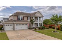 Charming two-story home with a three-car garage and manicured lawn at 110 Ricewood Ln, Moncks Corner, SC 29461