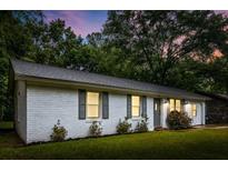 Charming white brick home features a well-maintained lawn and inviting curb appeal at 120 Lisa Dr, Summerville, SC 29485