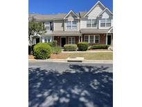 Charming townhome features a well-manicured front yard with lush landscaping at 145 Taylor Cir, Goose Creek, SC 29445