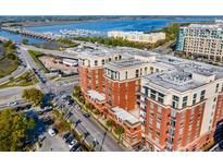 Stunning aerial view showcasing the building's architecture near the water and bridges with plenty of parking at 150 Bee St # 507, Charleston, SC 29401