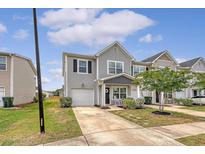 Charming two-story home with gray siding, well-manicured lawn, and an attached one car garage at 152 Kirkland St, Goose Creek, SC 29445