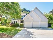 Charming two-story home featuring a three-car garage and a well-manicured lawn at 1541 Diamond Blvd, Mount Pleasant, SC 29466