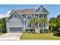 Charming two-story home with a garage, palm trees, a yellow front door, and a cozy bench in the front yard at 1644 Fort Palmetto Cir, Mount Pleasant, SC 29466