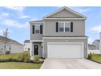 Charming two-story home with a two-car garage, landscaped yard, and grey siding with black shutters at 244 Wild Strawberry Ln, Moncks Corner, SC 29461