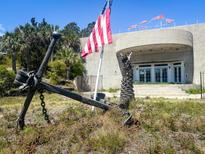 View of a structure with an anchor and flag in front at 3030 Brownell, Sullivans Island, SC 29482