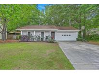 Charming one-story home with well-manicured lawn and attached garage in a serene setting at 3230 Landing Pkwy, North Charleston, SC 29420