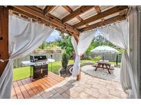 Inviting outdoor space with grill, picnic table, and covered patio for relaxing and entertaining at 3319 Dunwick Dr, Johns Island, SC 29455