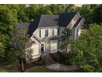 Charming two-story home with a landscaped yard and a welcoming entrance with green surroundings at 4213 Club Course Dr, North Charleston, SC 29420