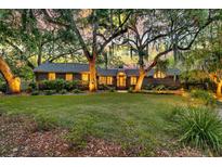Charming brick home with a sprawling front lawn, mature trees, and inviting curb appeal at 521 Pelzer Dr, Mount Pleasant, SC 29464
