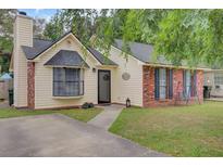 Charming single-Gathering home with brick accents, black shutters, and a well-manicured lawn at 1019 Tj Ln, Summerville, SC 29486