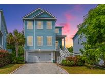 Charming two-story home with blue siding, white trim, garage, and well-manicured landscaping at 133 Alder Cir, Charleston, SC 29412