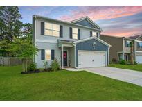 Charming two-story home with light grey siding, dark blue accents, and a well-manicured lawn at 141 Clydesdale Cir, Summerville, SC 29486