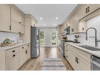 Modern kitchen features stainless steel appliances, white subway tile backsplash, and neutral-toned cabinets at 1541 Hutton Pl, Charleston, SC 29407
