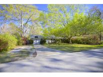 Charming single-story home with a well-manicured front yard, long driveway, and mature shade trees at 2138 Clayton St, Charleston, SC 29414