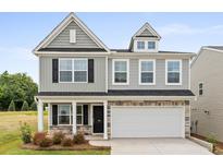 Charming two-story home with gray siding, stone accents, and a two-car garage at 333 O'Leary Circle, Summerville, SC 29483