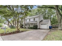 Charming two-story home with a well-manicured front yard, mature trees, and a spacious driveway at 543 Castle Hall Rd, Mount Pleasant, SC 29464