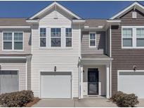 Charming townhome exterior featuring a one-car garage and well-maintained landscaping at 619 Hilchot Dr, Summerville, SC 29486