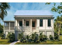 Charming white two-story home with a inviting front porch and beautiful tropical landscaping at 7059 Sounding Ln, Johns Island, SC 29455