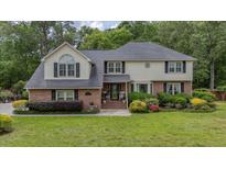 Charming two-story home with brick and siding exterior, lush landscaping, and a well-maintained lawn at 122 Hidden Fawn Cir, Goose Creek, SC 29445