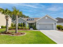 Charming single-story home with a well-manicured lawn, inviting curb appeal, and attached two car garage at 1245 Hammrick Ln, Johns Island, SC 29455