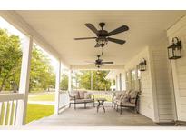 Inviting back porch featuring neutral furniture, ceiling fans, and stylish lighting, perfect for outdoor relaxation at 201 Welles Ln, Walterboro, SC 29488