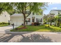 Charming two-story home with a well-manicured lawn, mature tree, and a driveway leading to an attached garage at 2132 Summerwood Dr, Mount Pleasant, SC 29466