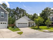Charming white single-Gathering home features a two-car garage and well-manicured landscaping at 3121 Harding Ct, Johns Island, SC 29455