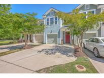 Charming townhome with a blue shingle exterior, red front door, and well-maintained landscaping at 3367 Eastman Dr, Mount Pleasant, SC 29466