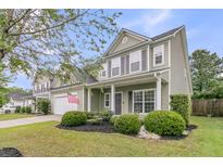 Charming two-story home featuring an attached garage, manicured lawn, and neatly trimmed landscaping at 3537 Galaxy Rd, Ladson, SC 29456