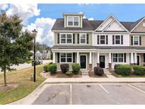 Charming townhome with a well-maintained lawn and parking in front at 394 Flyway Rd, Goose Creek, SC 29445
