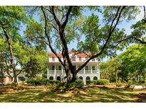 Charming two-story home with a red roof and a sprawling front yard at 554 Parrot Point Dr, Charleston, SC 29412