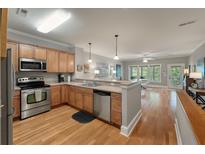 Open concept kitchen with stainless steel appliances and wood cabinets at 626 Windermere Blvd # 4D, Charleston, SC 29407