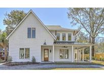 Inviting two-story home with white siding, a covered front porch, and craftsman-style details at 755 Adluh St, Mount Pleasant, SC 29464