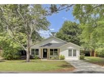 Charming single-story home with a welcoming front porch and well-manicured lawn at 115 Ridge Rd, Summerville, SC 29485