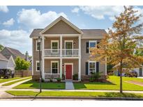 Charming two-story home with a welcoming front porch and well-manicured lawn in a suburban neighborhood at 1417 Roustabout Way, Charleston, SC 29414