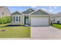 Charming home with manicured lawn, attached garage and delightful curb appeal at 212 Rubles Ln, Moncks Corner, SC 29461